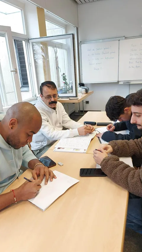 Students practising German writing in class
